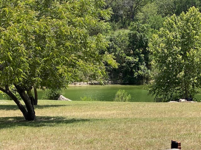The Blanco River, still under live oaks, in summer