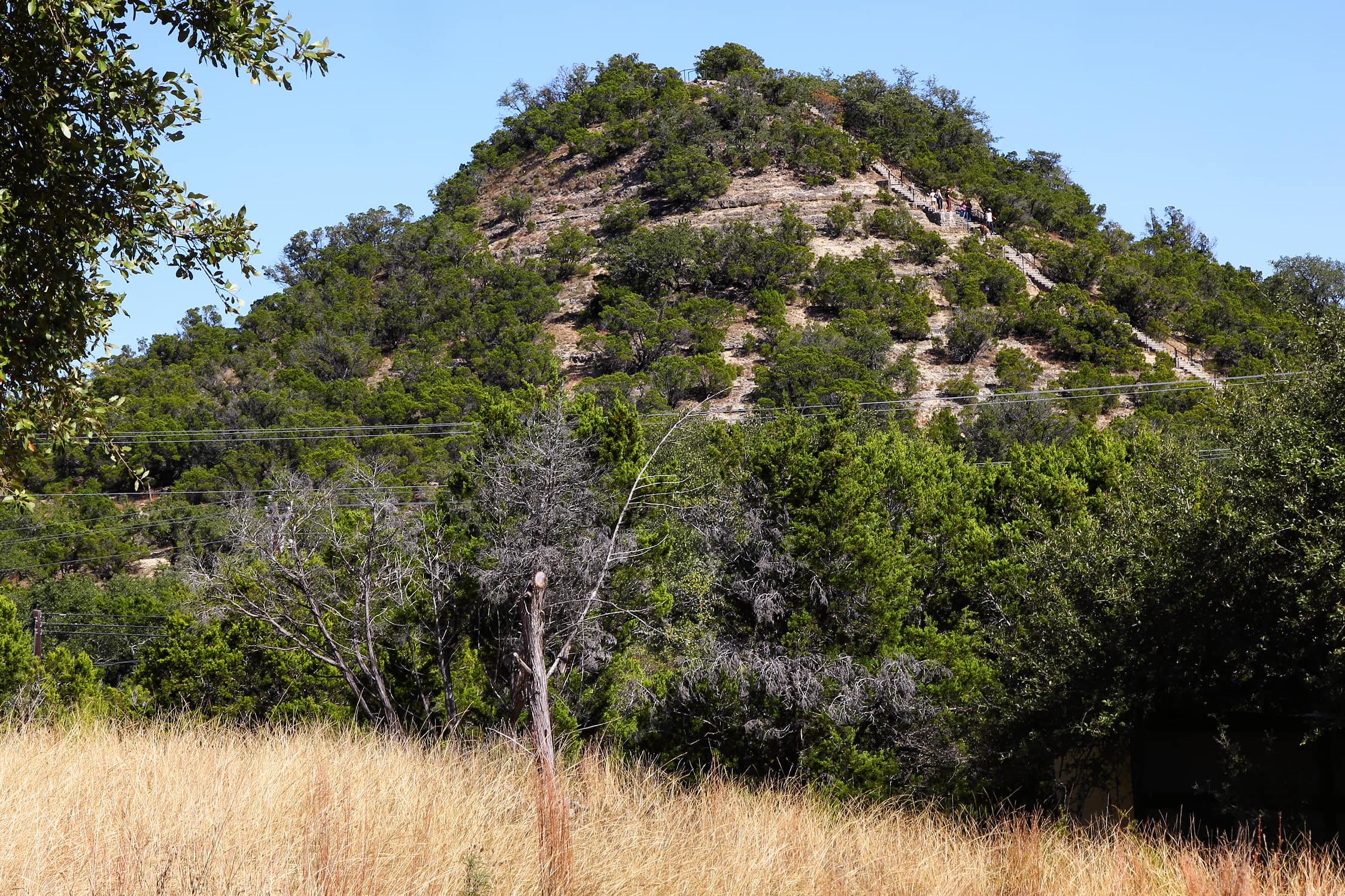 Old Baldy, the limestone hill above Wimberley, under a late-summer sky